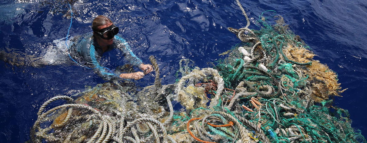 Image of Emily Penn attaching GPS tracker to ghost nets